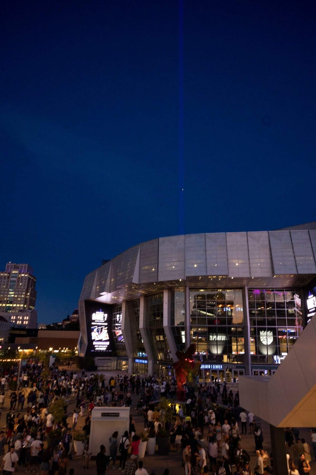 The beam is faintly visible at Golden 1 Center as dusk falls after the Game 6 watch party for the the first-round NBA playoff series between the Sacramento Kings and the Golden State Warriors in San Francisco on Friday.
