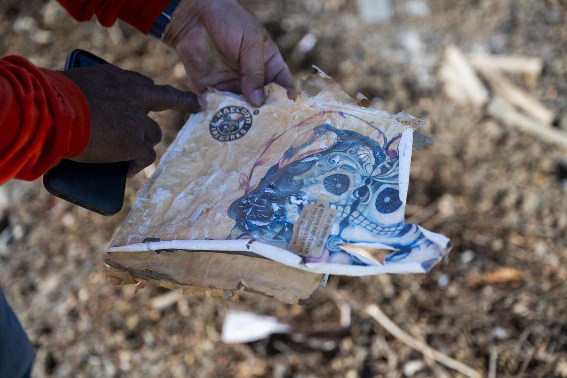Jimmy Gerardo, a curious visitor to the Esparto fireworks site from Vacaville, holds the remains of a Raccoon Fireworks box on Thursday.