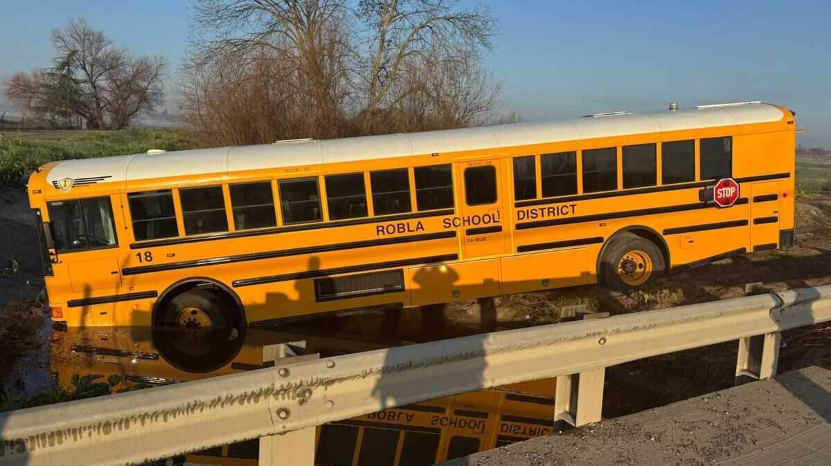 A Robla School District bus rests in Magpie Creek after it veered off Raley Boulevard in North Sacramento on Monday, Feb. 2, 2026. No students were injured, authorities said.