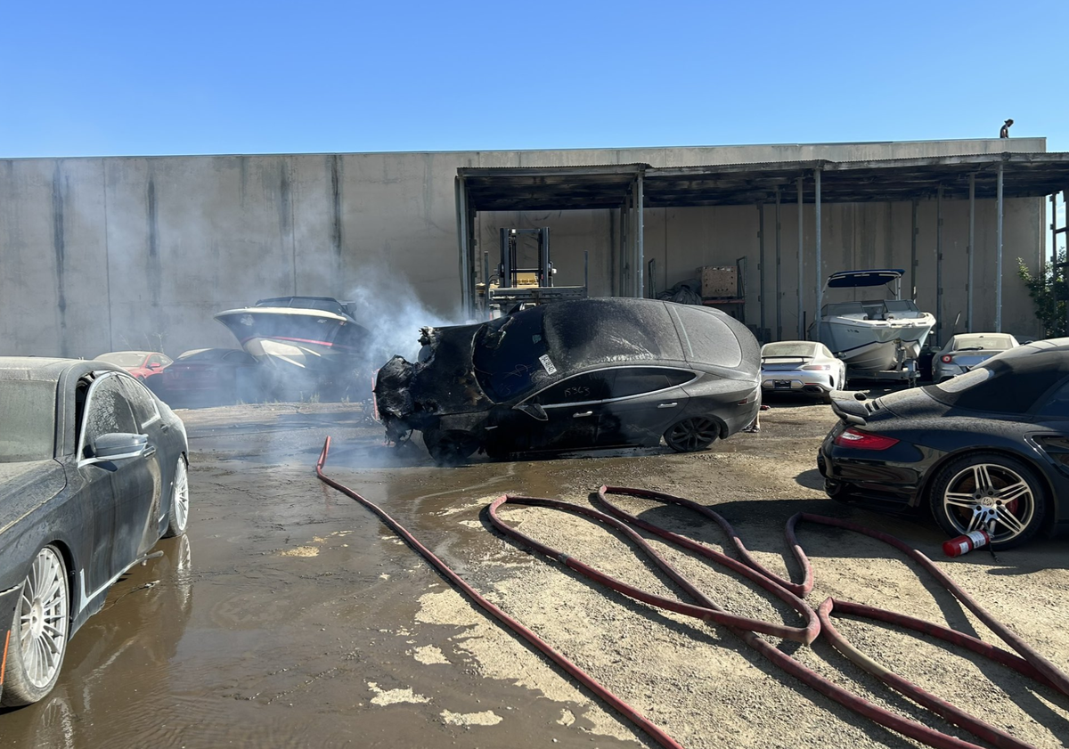A Tesla Model S smolders after its battery caught fire at an auto dismantling yard Wednesday, Aug. 2, 2023, in Rancho Cordova.
