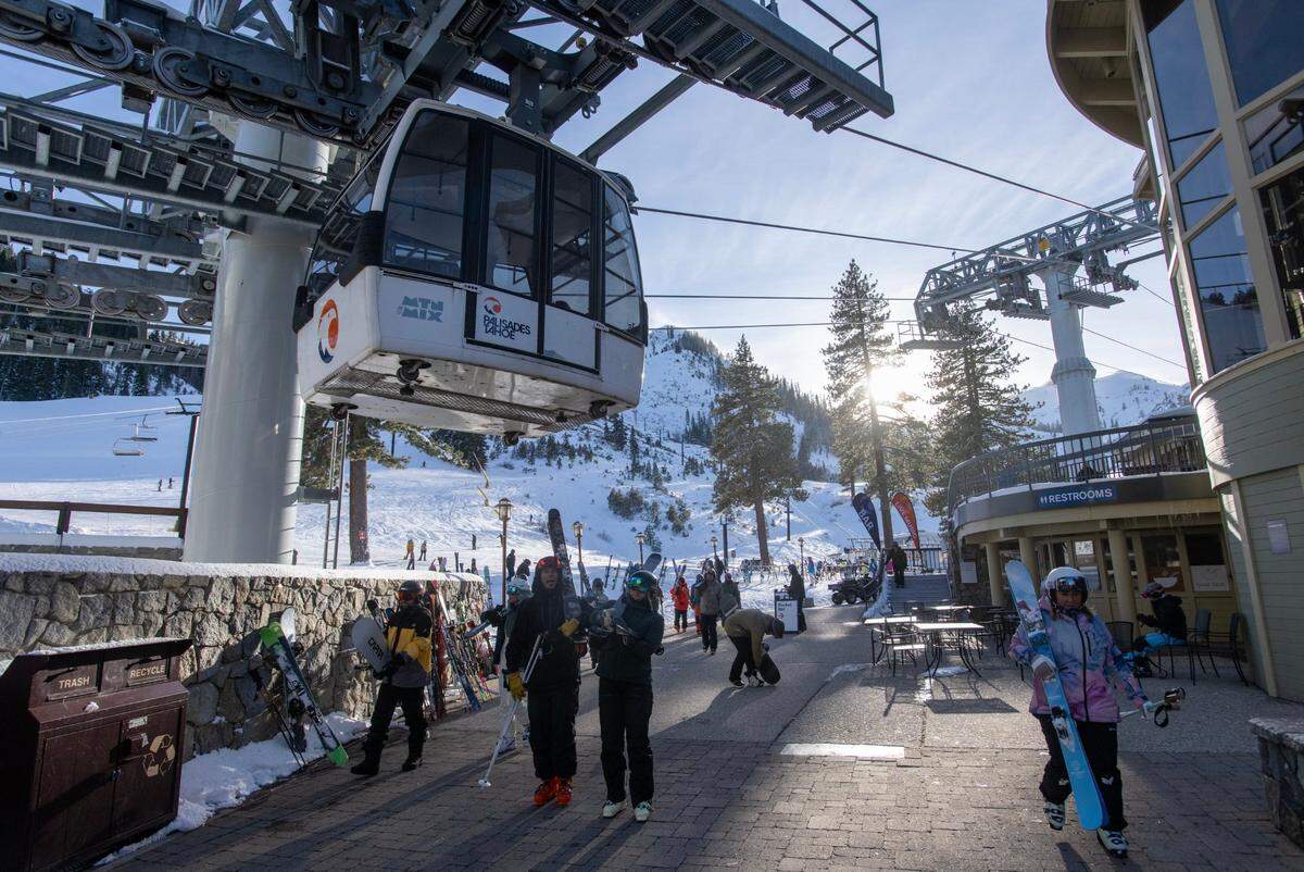 Skiers and snowboarders finish a run at Palisades Tahoe in January 2024. 