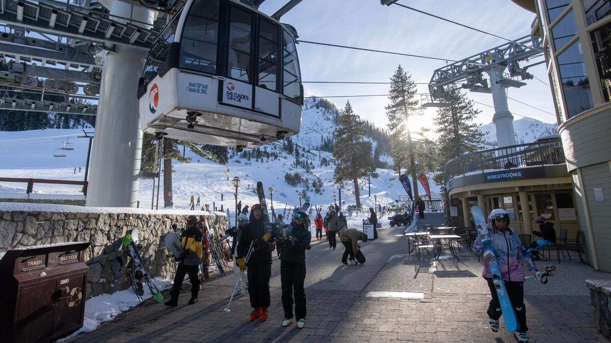 Skiers and snowboarders finish their day at Palisades Tahoe last year.