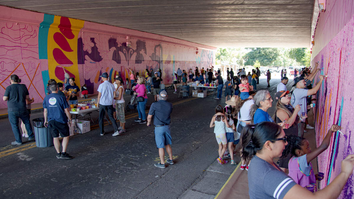 Residents join to create a mural under Highway 99 Saturday, July 8, 2023, in Sacramento as part of the Clean California South Sac Safety and Beautification Project, co-led by Jaya King and Uli Smith.