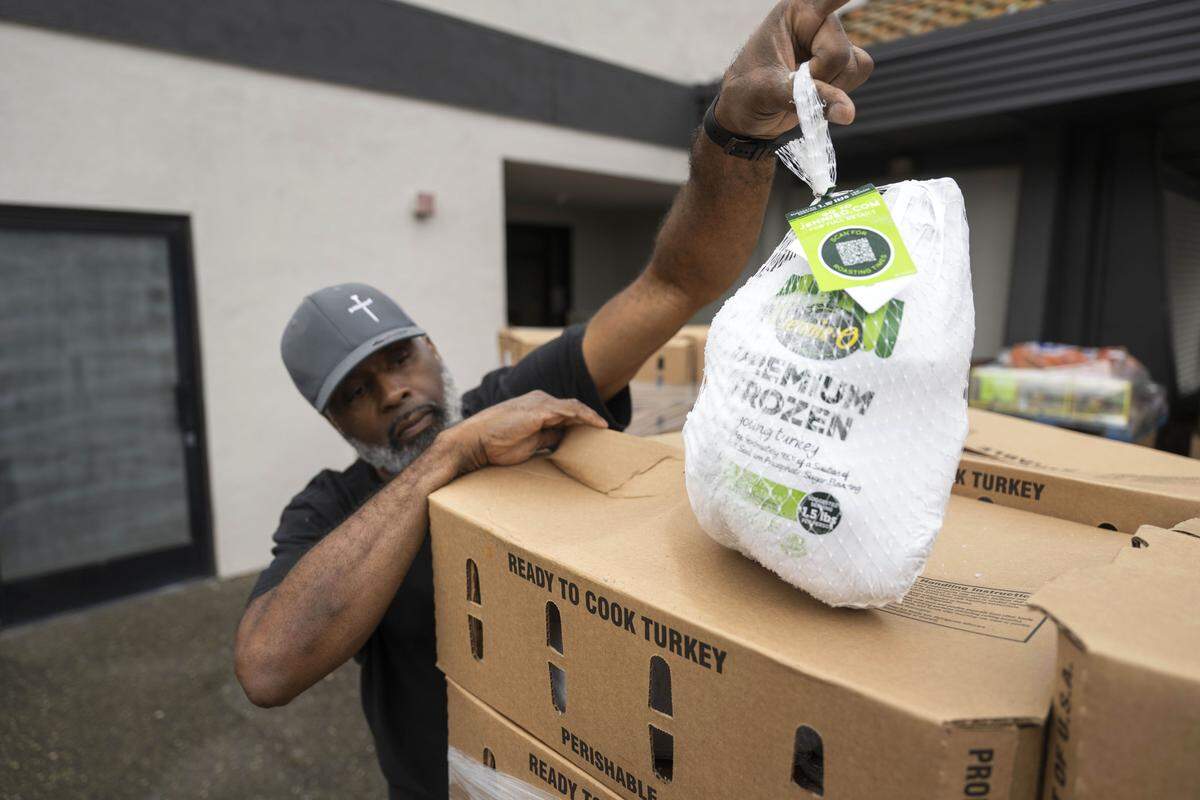 Matthew Parker with South Sacramento Christian Center checks one of the turkeys that was delivered by the Sacramento Food Bank last week.
