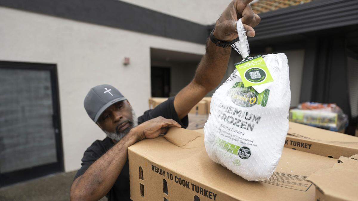 Matthew Parker with South Sacramento Christian Center checks one of the turkeys that was delivered by the Sacramento Food Bank for Thanksgiving meals. State lawmakers are looking for ways to compensate for the loss of billions of dollars in federal food aid. 