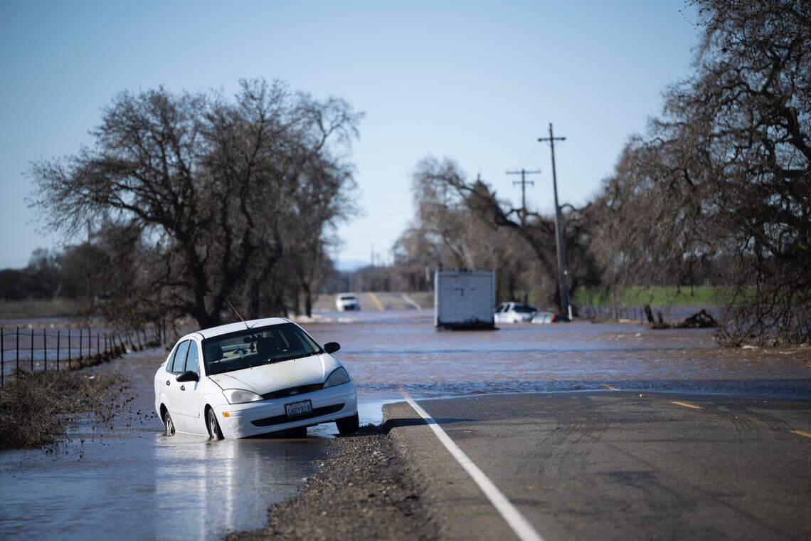Abandoned vehicles rest in floodwaters on Dillard Road on Sunday, Jan. 1, 2023, after heavy rainfall on New Year’s Eve caused levee breaks near Wilton.