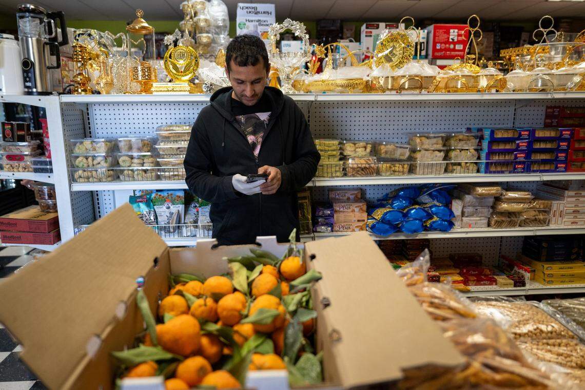 Recent immigrant Abdul Basir Ahmadi works part-time at Noble Halal Grocery in Yuba City last month. Ahmadi, who found the job through county employment services, arrived less than a year ago with his wife and four children on a special immigrant visa.