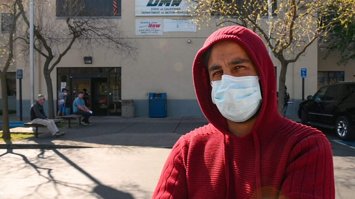 Ahmad Usufy, of Sacramento, waits outside the Broadway DMV office on Friday, March 13, 2020 in Sacramento. Usufy says he is very concerned about the coronavirus and going out to public places like the DMV – where he says most people are not taking the proper precautions – makes him nervous. Usufy said he wears his face mask when in public, washes his hands regularly and keeps his distance from others. DMV offices remain open despite Governor Newsom’s order that events with more than 250 people be canceled and people should do social distancing to reduce spread of the coronavirus.