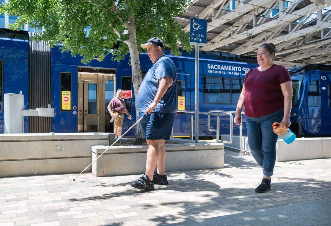 Rick Hodgkins, who is visually impaired, and Alexandria Mendibles exit a new S700 low-floor light rail train using an access ramp at the Township 9 station in Sacramento on Wednesday. While inside the train, Hodgkins and Mendibles spoke with a Sacramento Regional Transit light rail maintenance supervisor to better understand the vehicle’s various safety and accessibility features.