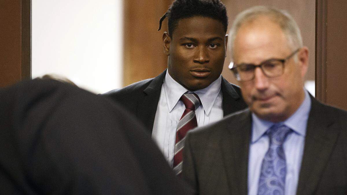 49ers linebacker Reuben Foster, background, arrives with his attorney, Joshua Bentley, right, for an arraignment at the Santa Clara County Hall of Justice in San Jose on April 12. Foster has been charged with felony domestic violence after being accused of attacking his girlfriend, authorities said.