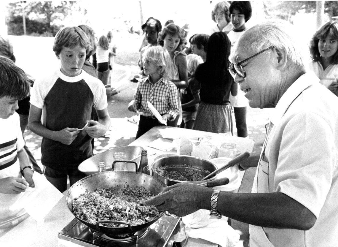Frank Fat uses Wok to teach youngsters how to make Fried Rice at Kids-on-Kampus Across the years program Friday.