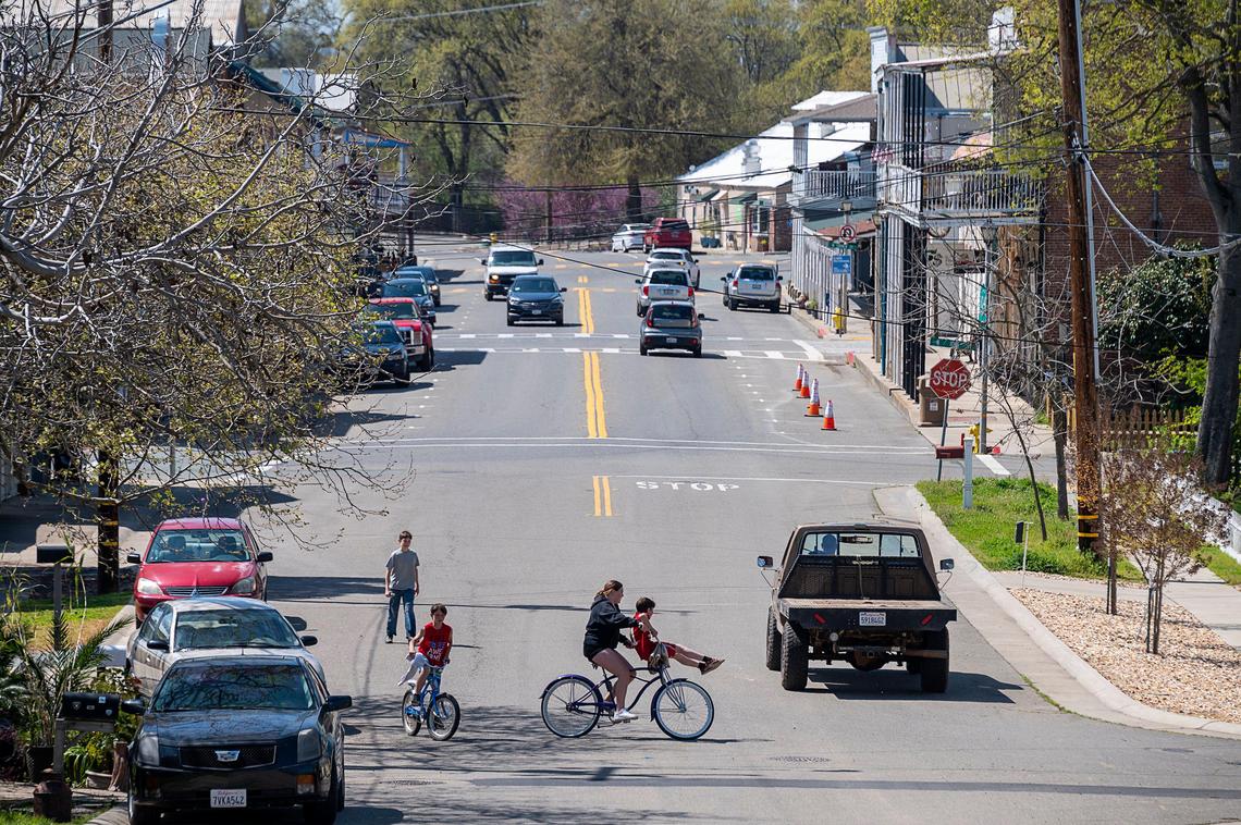 Residents on bicycles share the road with cars on East Main Street on Friday, March 27, 2020 in Ione. Amador County residents have cut their average distance traveled by more than 45% during the coronavirus crisis, according to a review of smartphone data.