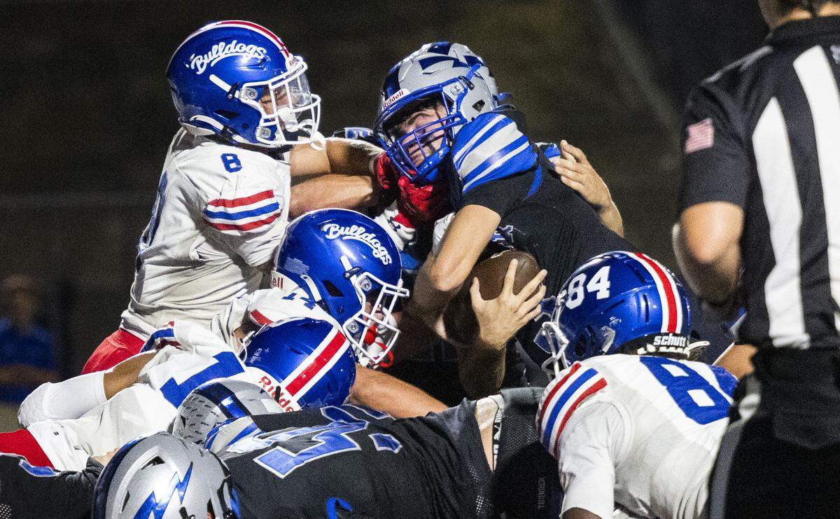 Rocklin High School quarterback Reeve Slone (3) is stopped at the goal line by Folsom High School defenders during a high school football game on Friday in Rocklin.