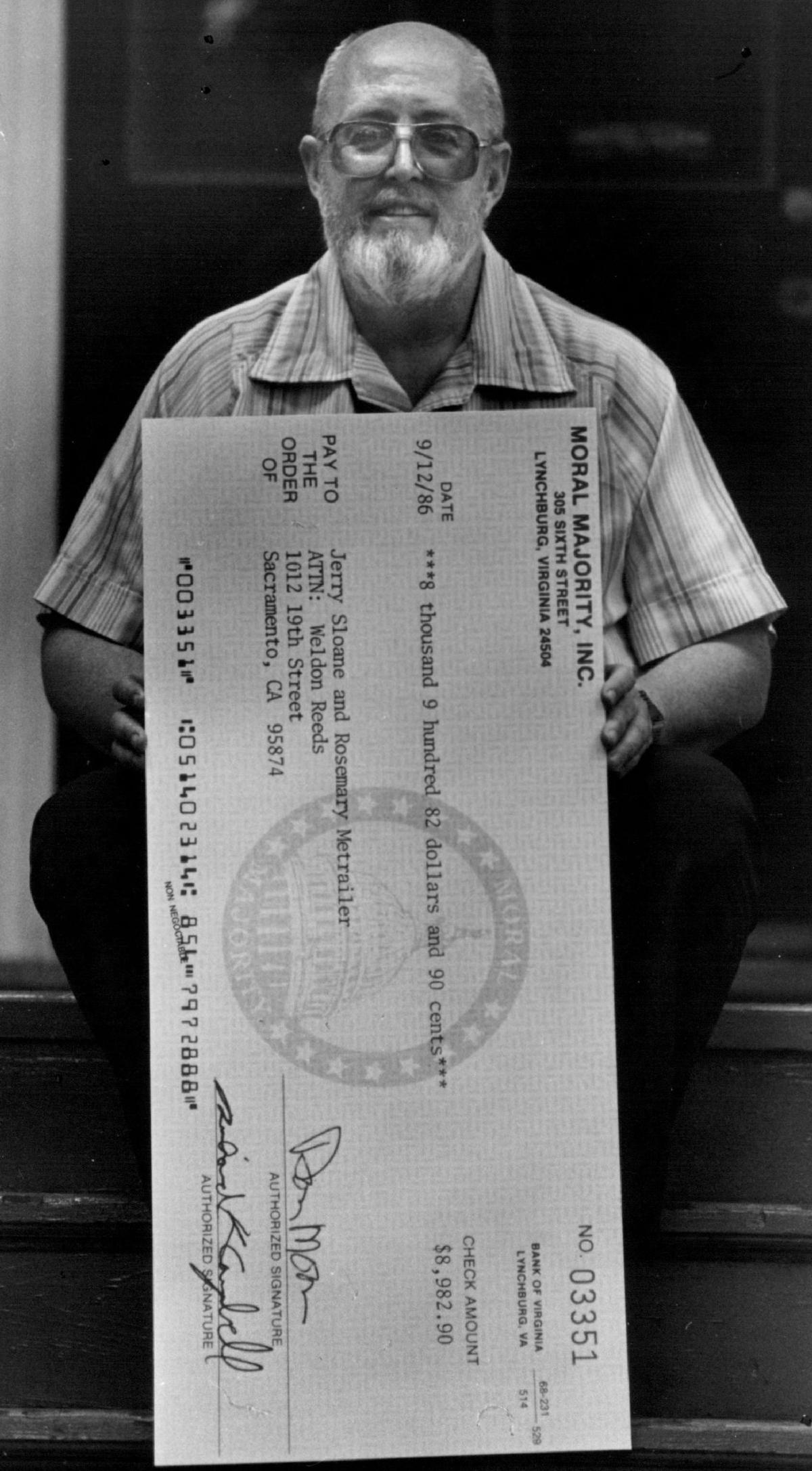 “I have been vindicated,” said Sacramento resident Jerry Sloan, former pastor of the predominately gay Metropolitan Community Church, holding a blowup of an $8,982.90 settlement check from Jerry Falwell’s Moral Majority Inc. in 1986. Sloan said he planned to use his share of the funds on the gay and lesbian Lambda Community Center in midtown Sacramento.