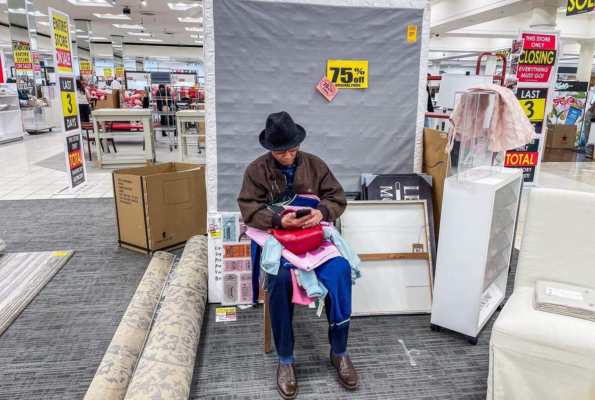 A customer sits on a chair at the Downtown Commons Macy’s store in Sacramento on Thursday.