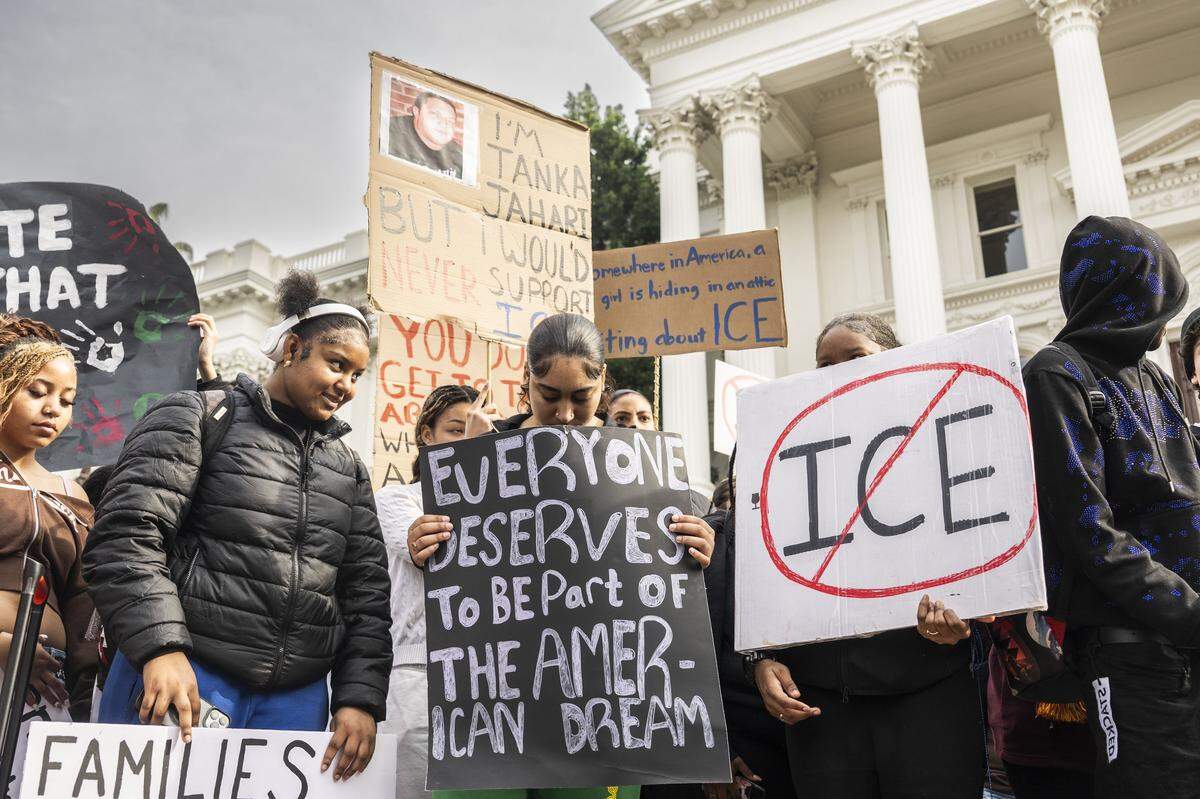 Burbank High student Delaura Johnson holds a sign that says "everyone deserves to be part of the American dream" as she participates in a protest against ICE at the state Capitol on Friday.