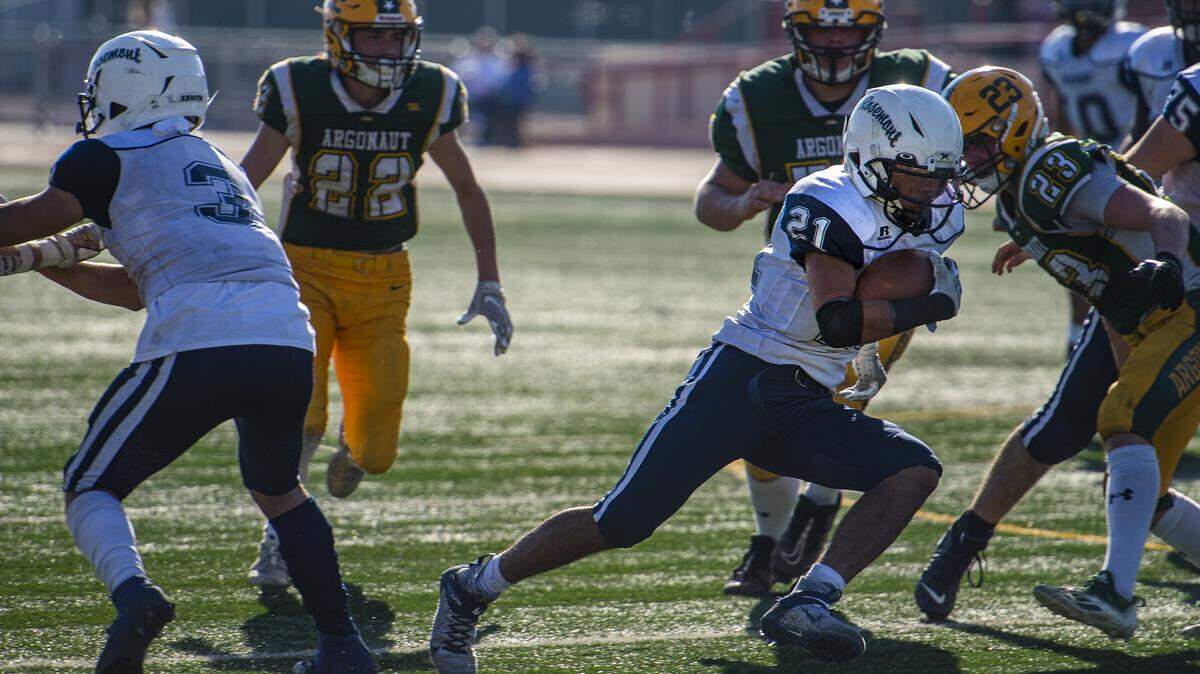 Rosemont Wolverines running back Michael Cherry (21) darts through the Argonaut Mustangs defense for a first down during the second quarter of the CIF Sac-Joaquin Section Division VI championship game on Saturday, Nov. 27, 2021, at Hughes Stadium in Sacramento. The Mustangs won 31-20.