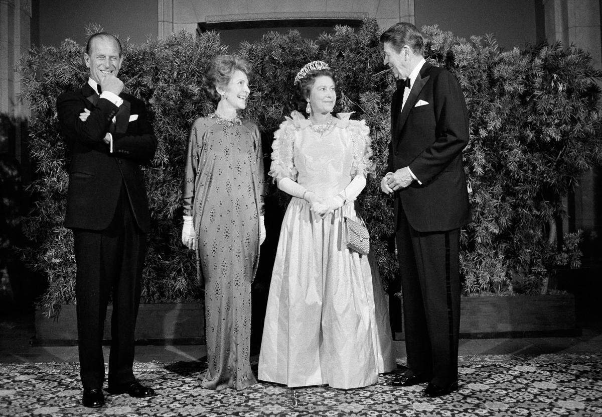 President Ronald Reagan and first lady Nancy Reagan pose for photographers with Queen Elizabeth II and Prince Philip at a formal state dinner, March 3, 1983, at the M.H. de Young Museum in San Francisco’s Golden Gate Park.