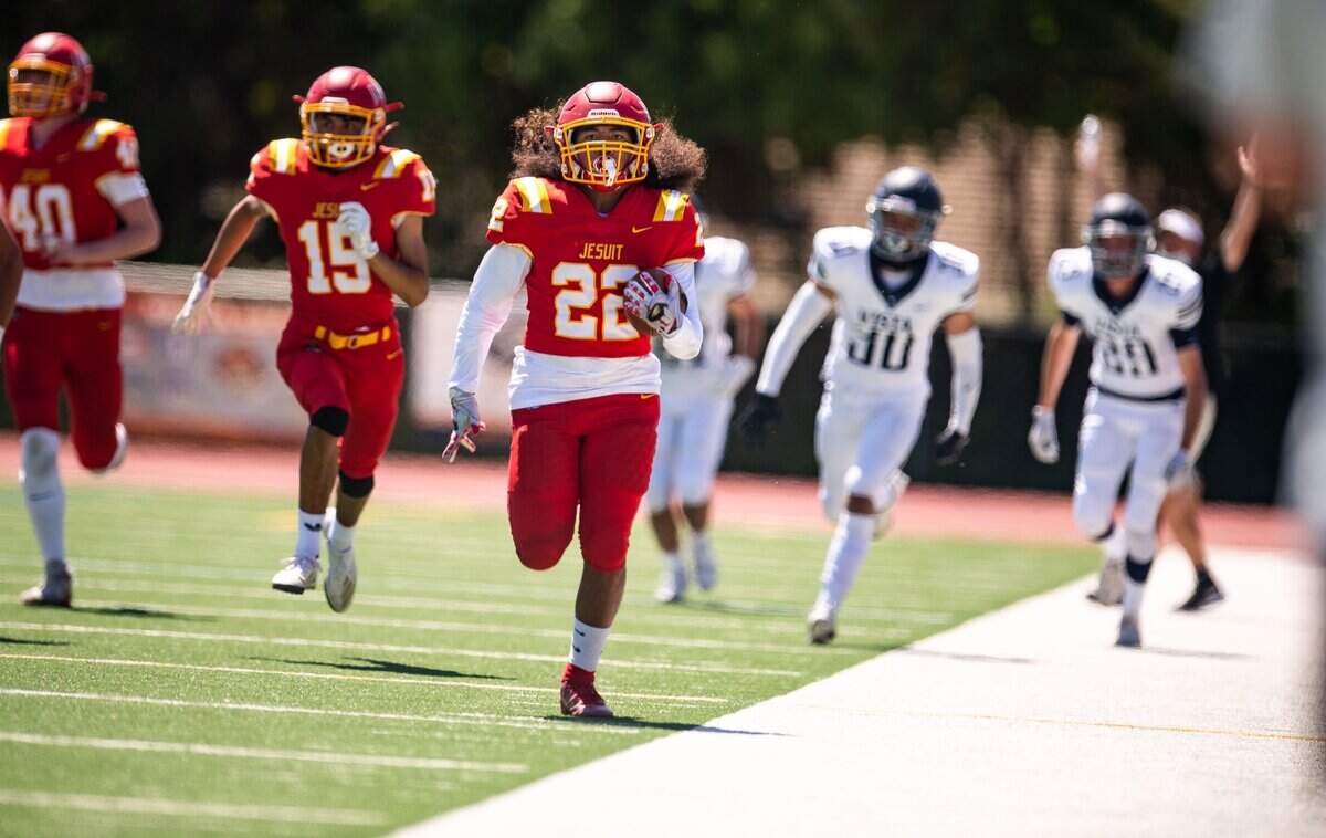 Jesuit running back Kai Santos sprints down the sideline for a touchdown against Vista del Lago in April. 