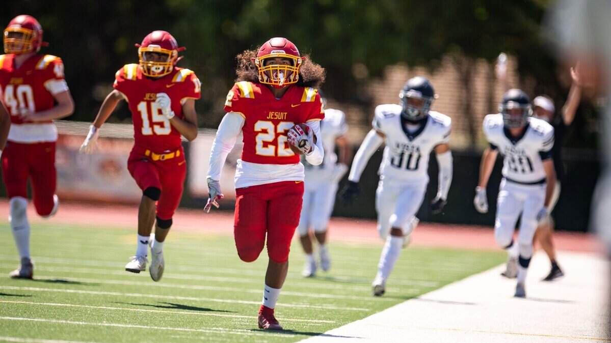 Jesuit running back Kai Santos sprints down the sideline for a touchdown against Vista del Lago on Saturday at Jesuit High School. Santos ran for 213 yards and had touchdowns of 74 and 76 yards.