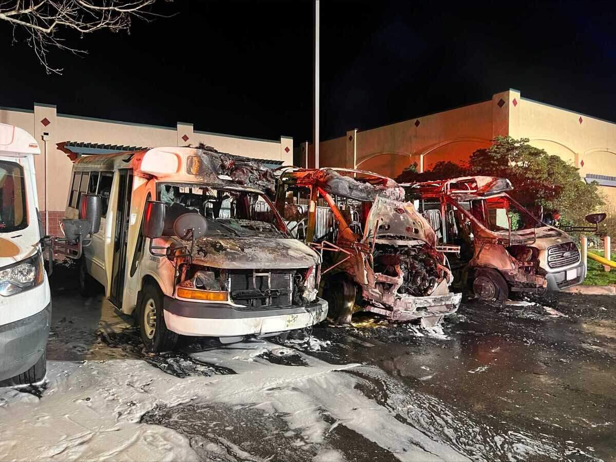 The remains of three buses are seen Sunday, Feb. 12, 2023, following a fire at Elk Grove KinderCare. Arson officials are investigating the incident.