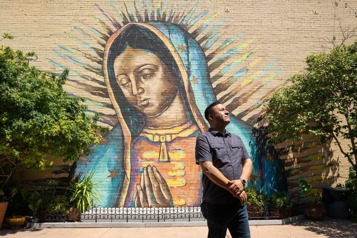 Oscar Escobar stands in front of a mural at Placita MX in Sacramento on Wednesday. Located on K Street in midtown Sacramento, Placita MX is a plaza featuring Latino-owned businesses, public art, crafts and Indigenous healing practices centered on community and cultural traditions.