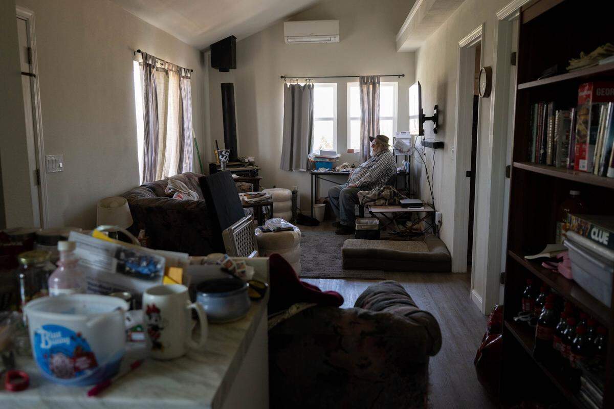 Mac MacNeil, 78, sits on May 1 in his rebuilt 750-square-foot home in Grizzly Flats, which was restored with funding from the Non-Profit Construction Corporation following the 2021 Caldor Fire. 