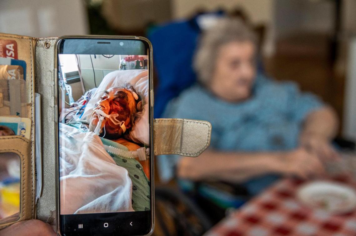 As Alla Naidenko, 82, eats fresh tomatoes in the background&nbsp;on Tuesday Aug. 11, 2020&nbsp;as her daughter-in-law Irina Pchelnikova shows a photo of her condition after a medical procedure at Sutter Roseville Medical Center. The family has filed a lawsuit against Sutter Health and its affiliates in Placer Superior Court on their mother’s behalf, alleging negligence in the care and elder abuse.