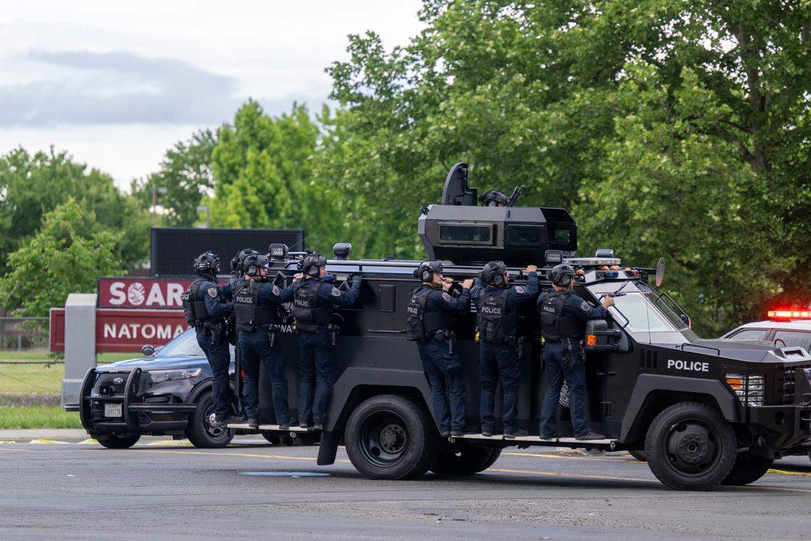 Sacramento police officers ride a BearCat armored vehicle as they search for a suspect at the Natomas Village apartments after a shooting at Natomas High School that left one student dead in Sacramento on Friday, April 10, 2026.