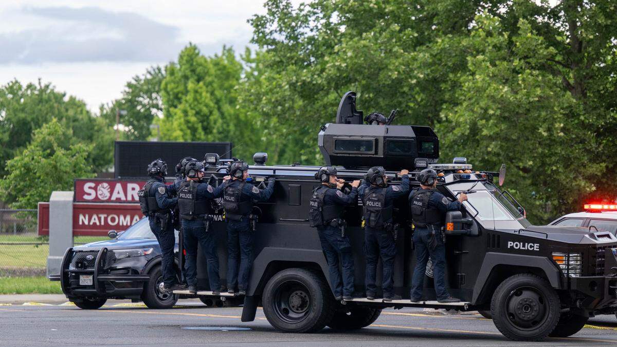 Sacramento police officers ride a BearCat armored vehicle as they search for a suspect in Sacramento on Friday, April 10, 2026.