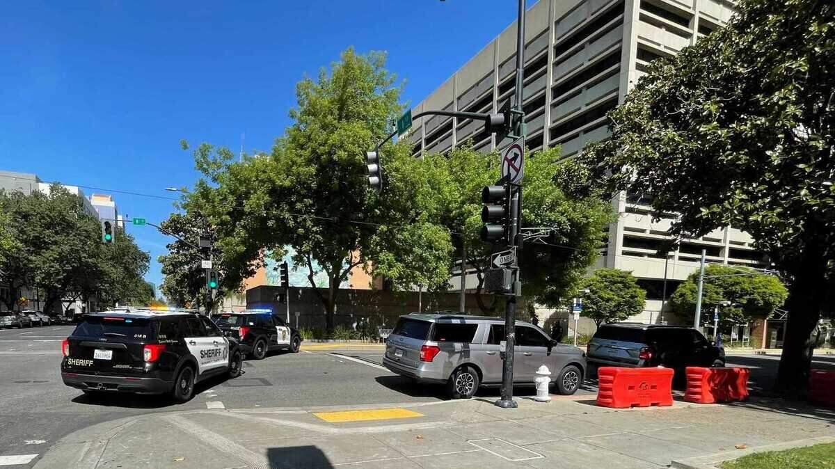 Law enforcement vehicles block traffic at Seventh and H streets in downtown Sacramento on Monday, May 6, 2024, after authorities discovered an abandoned suspicious package on the steps of the county administrative building. The item was deemed safe and the roadways reopened quickly.