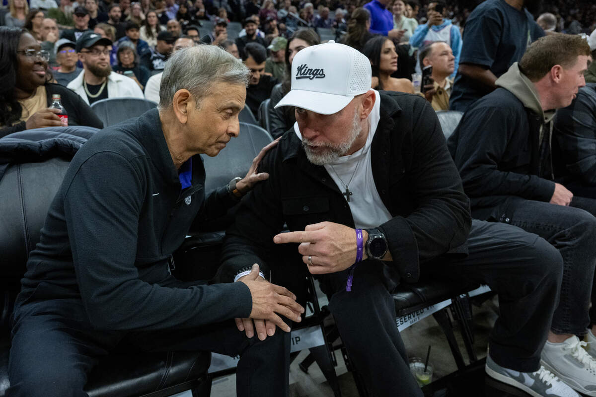 Kings owner Vivek Ranadivé talks with A’s manager Mark Kotsey before an NBA game at Golden 1 Center on Monday night.