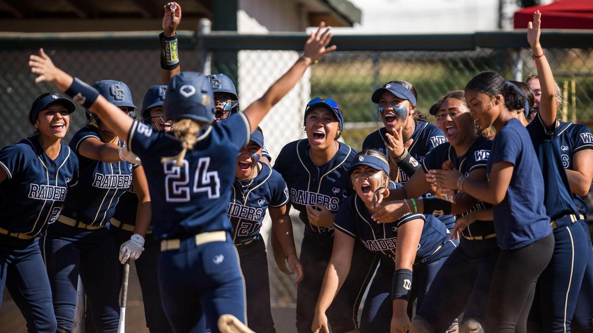 Central Catholic Raiders players greet batter Emori Machado (24) after her solo home run in the fourth inning against the Ponderosa Bruins during the CIF Northern California Division III softball championship game Saturday, June 3, 2023, at Ponderosa High School in Shingle Springs. The Raiders beat the Bruins, 7-0, for the NorCal title.