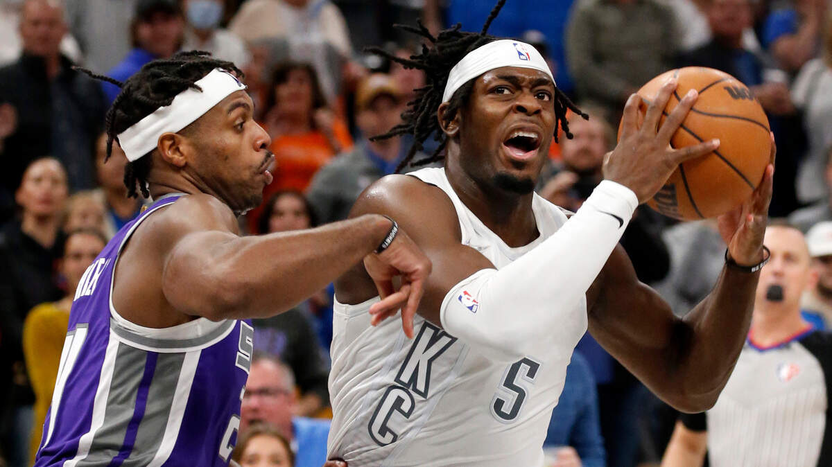 Oklahoma City Thunder forward Luguentz Dort (5) goes against Sacramento Kings guard Buddy Hield (24) in the final moments of an NBA basketball game, Friday, Nov. 12, 2021, in Oklahoma City. (AP Photo/Garett Fisbeck)