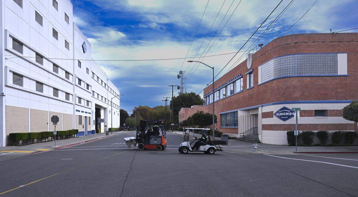 Employees drive between the buildings on Nov. 11. as the Blue Diamond plant in Sacramento prepares to close sometime between late 2026 and mid-2027.