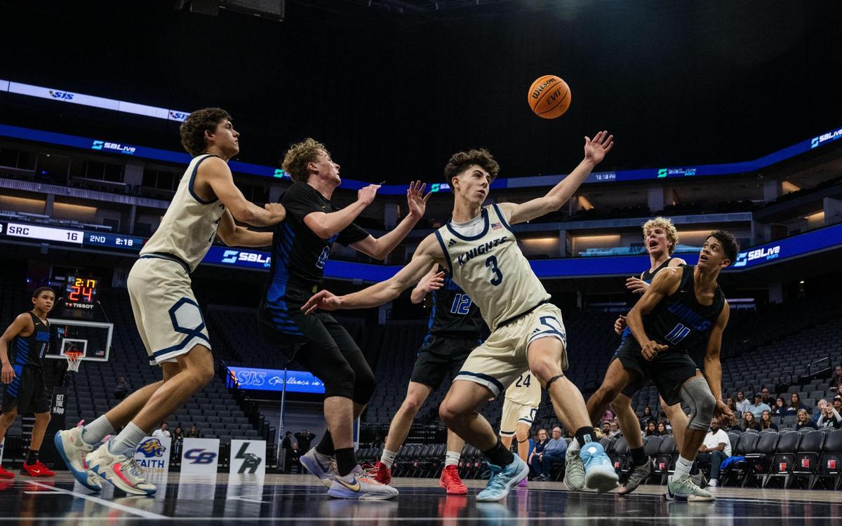 The Stone Ridge Christian Knights’ Cooper Trost (3) loses the ball under the basket to the Sacramento Waldorf Waves’ Malachi Miranda (11) during a CIF Sac-Joaquin Section Division VI boys basketball championship game at Golden 1 Center on Thursday, Feb. 27, 2025.
