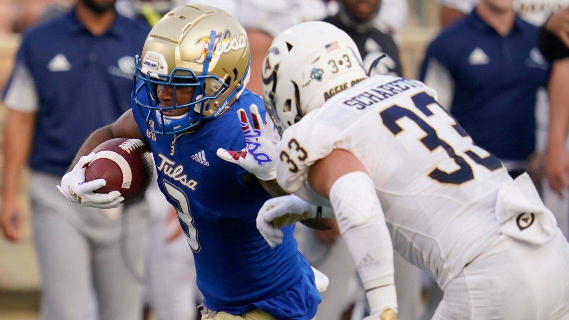 Tulsa running back Shamari Brooks is tackled by UC Davis linebacker James Scharetg on Thursday night in Tulsa.