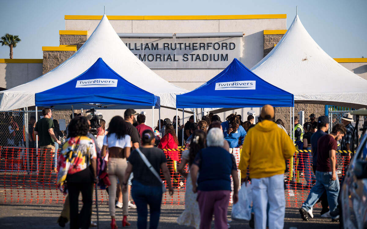 People line up for security screening at the Grant Union High School graduation ceremony on Thursday, June 1, 2023, in Sacramento’s Del Paso Heights neighborhood. An 18-year-old Grant senior set to graduate was killed in a North Highlands shooting the night before, authorities said.