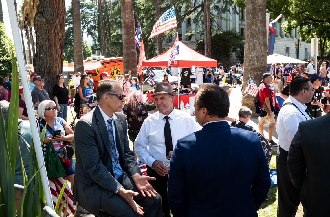 Pastor Paul Bertram, center, from Faith Mountain Pentecostal Church in Lakeside, mingles after speaking at “Liberty Fest,” a rally against Gov. Gavin Newsom’s coronavirus orders attended by about 2,000 people from across the state who support the immediate full reopening of California, on Saturday, May 23, 2020, outside the Capitol in Sacramento.