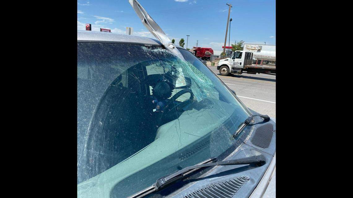 A Salt Lake City woman narrowly escaped injury when a piece of metal debris pierced her windshield on the highway, Utah police say.