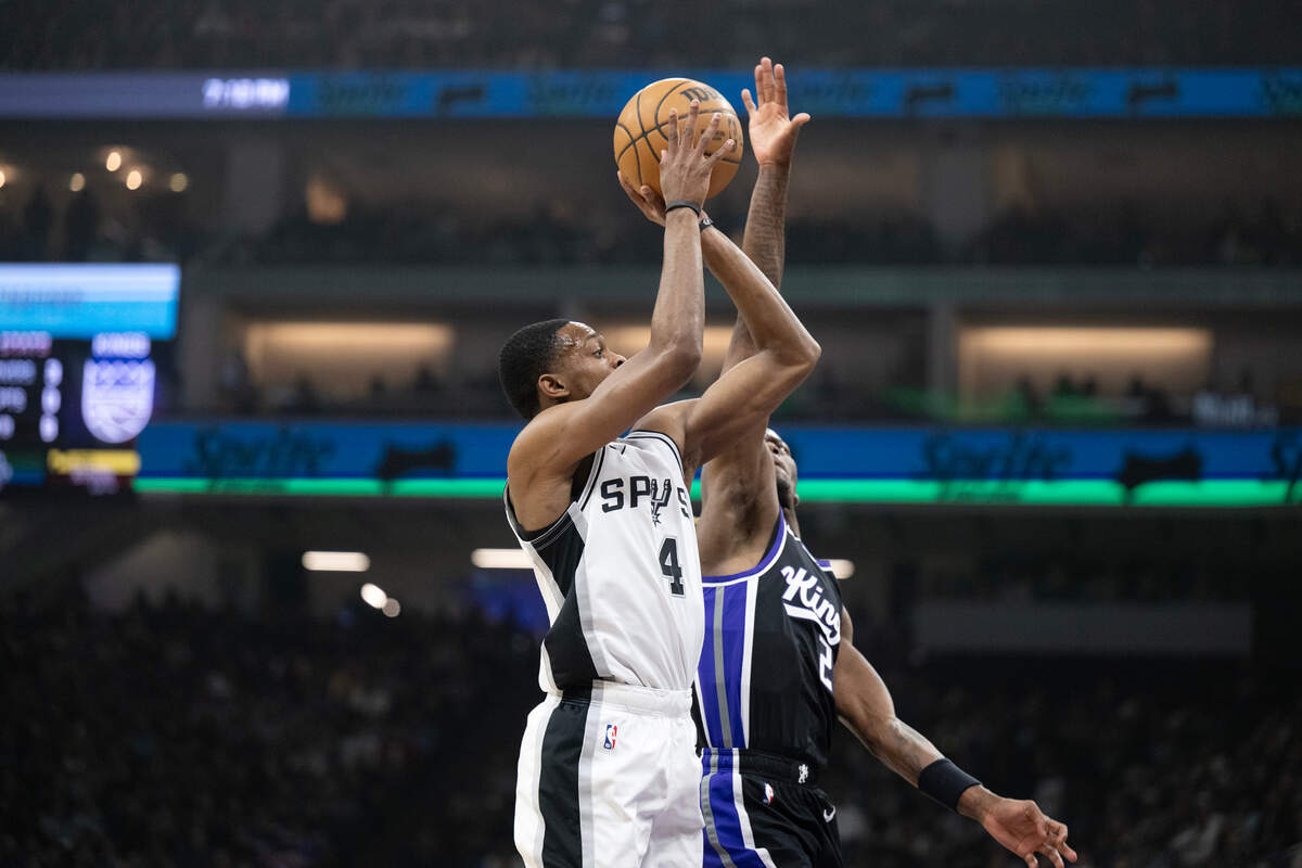 Sacramento Kings guard Keon Ellis (23) blocks the shot of San Antonio Spurs guard De’Aaron Fox (4) in the first half on Friday.