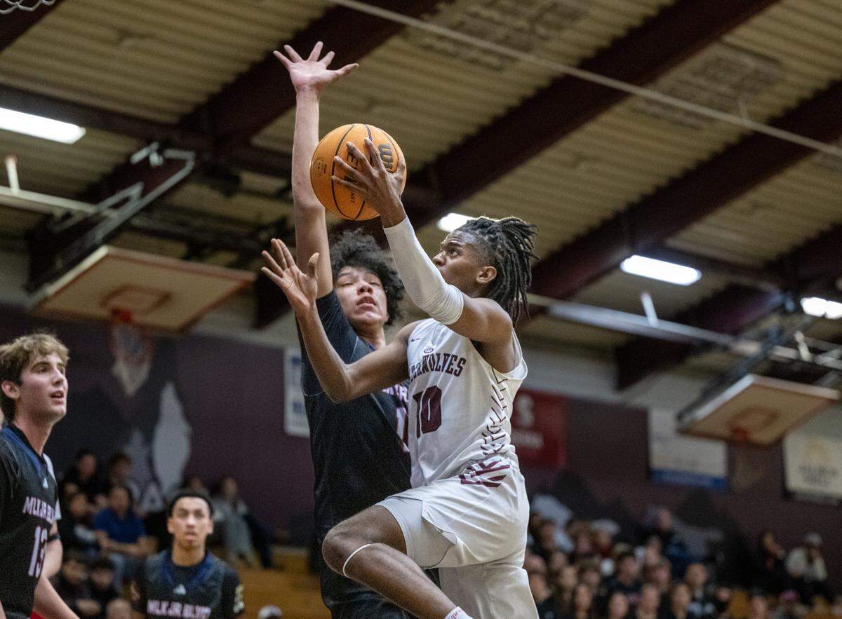 The Christian Brothers Falcons' Jaden DeJesus-Eves (11) defends The Woodcreek Timberwolves' Michael Kirby, Jr. (10) in the first half of a game on Thursday, Jan. 8, 2026 in Roseville.