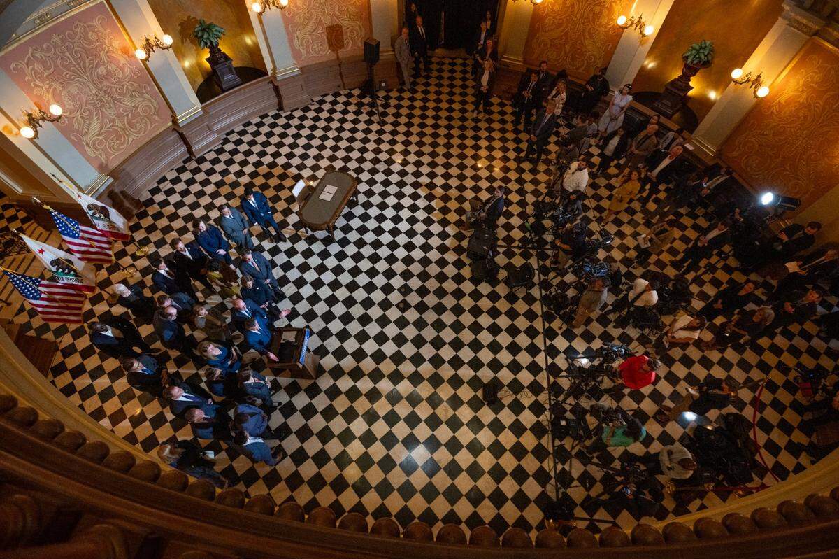 Gov. Gavin Newsom talks to the media with legislators and community leaders after signing bill intended to prevent gas price spikes at the state Capitol on Monday, Oct. 14, 2024.