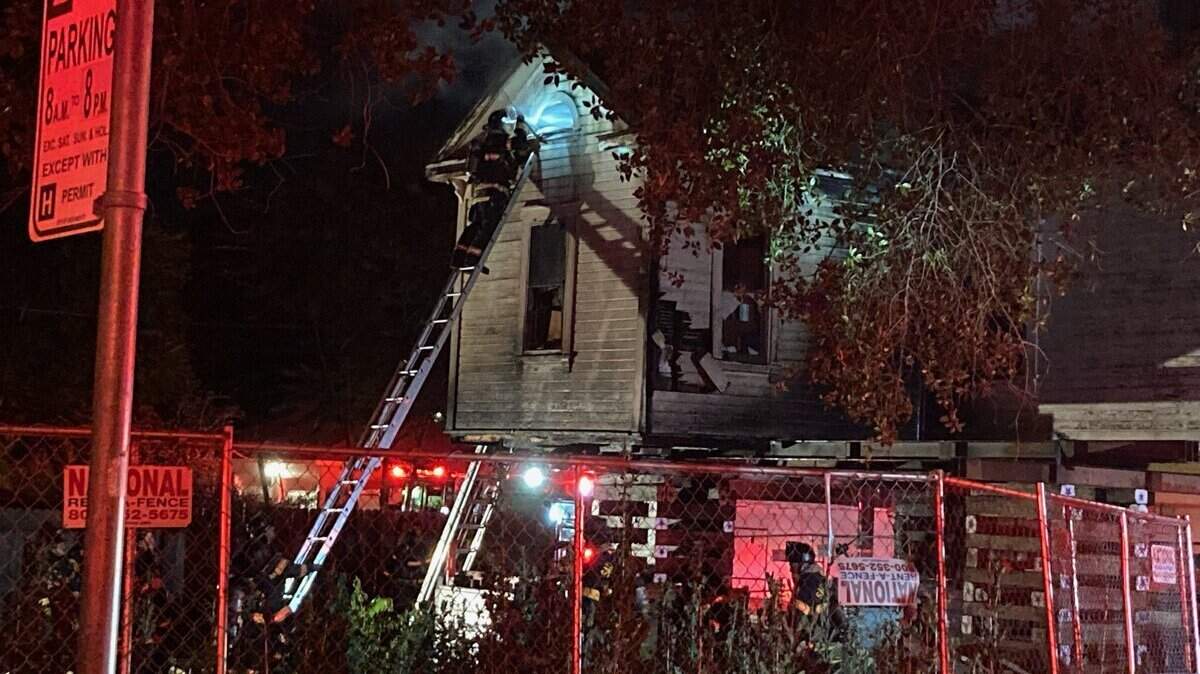 Firefighters are seen Monday, June 13, 2022, at a fire at a home in downtown Sacramento, Calif. Fire officials later said a person was arrested in connection with the blaze.