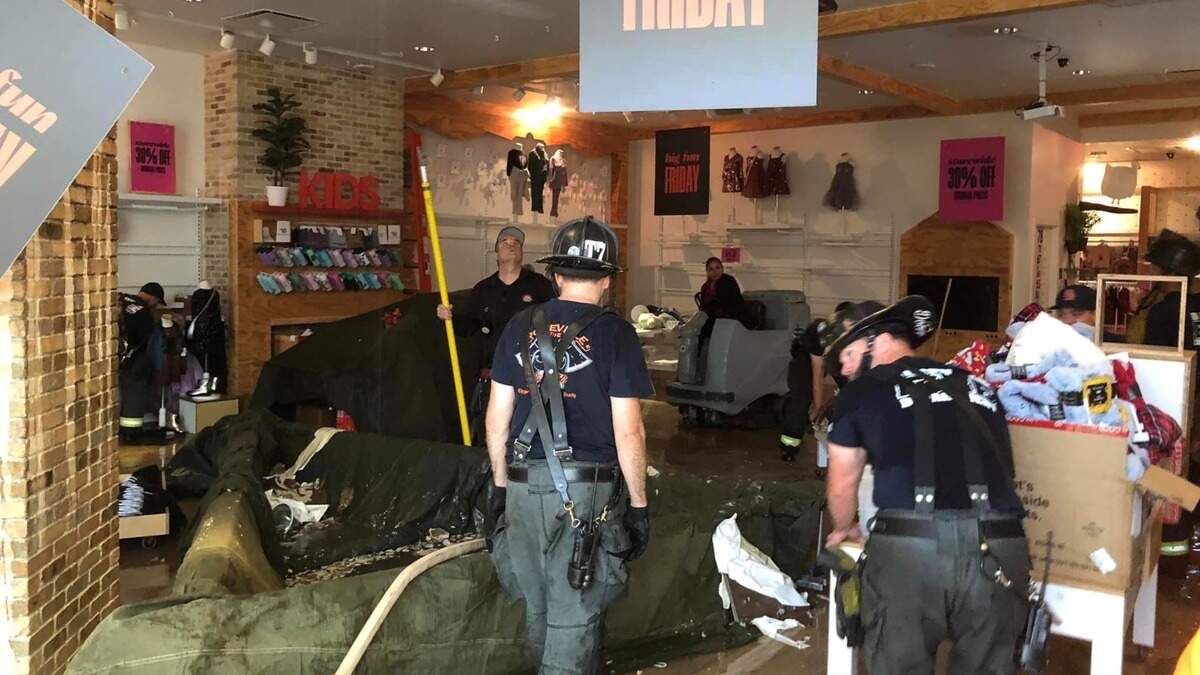 Firefighters work inside the Roseville Galleria mall Monday after the fire protection sprinkler system was accidentally activated.