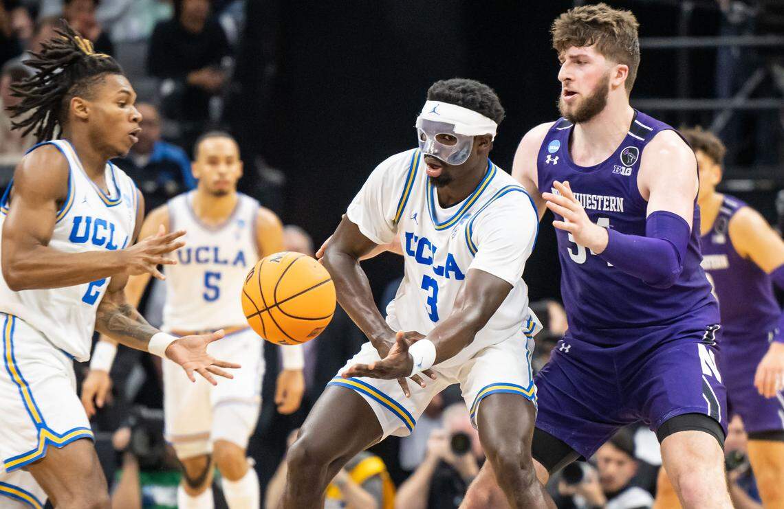 UCLA Bruins forward Adem Bona (3), right, passes the ball to guard Dylan Andrews (2) during the second half of their 2023 NCAA Tournament game.