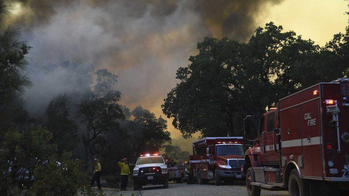 Black smoke from the Rices Fire blots out the Tuesday afternoon sunlight along Troost Trail in Nevada County.
