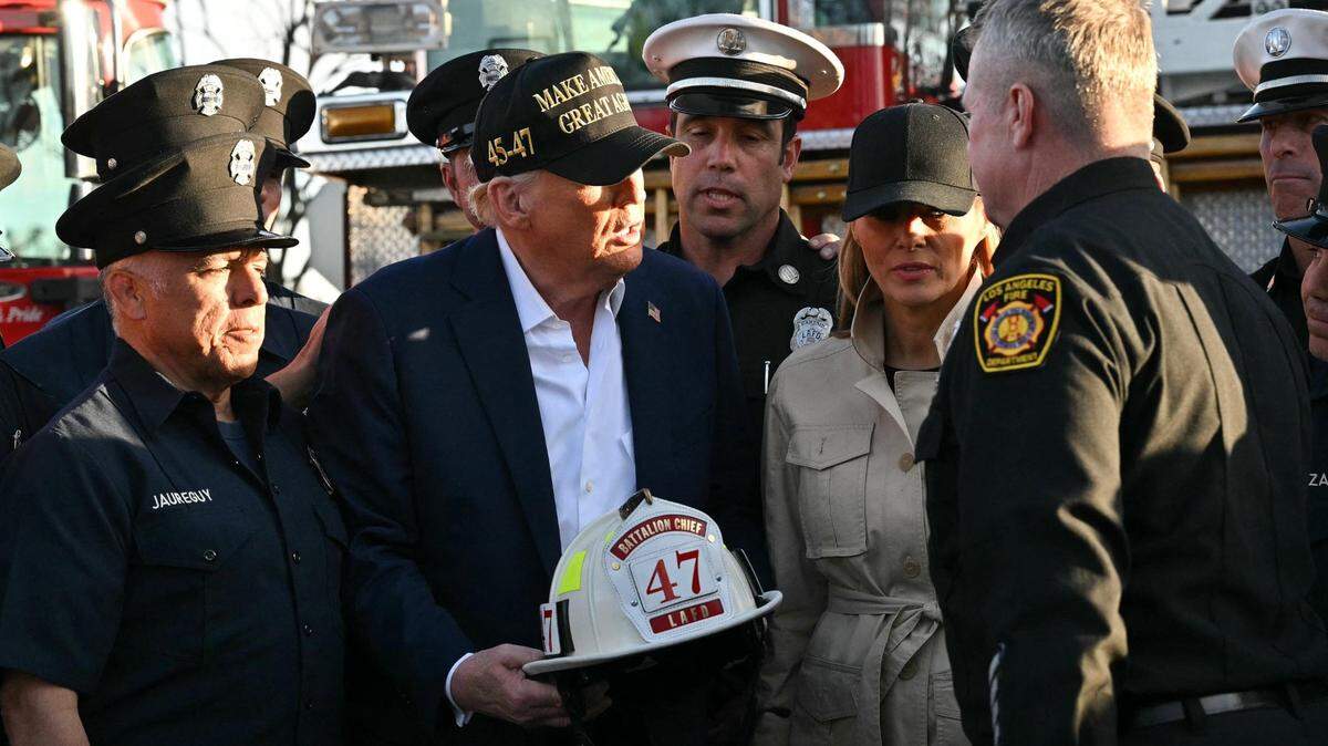 President Donald Trump and first lady Melania Trump with a helmet reading “Bataillon Chief 47” donated by firefighters from Station 69 as they tour a fire area in Pacific Palisades on Friday, Jan. 24, 2025. Trump’s false statements about California water are befuddling experts.