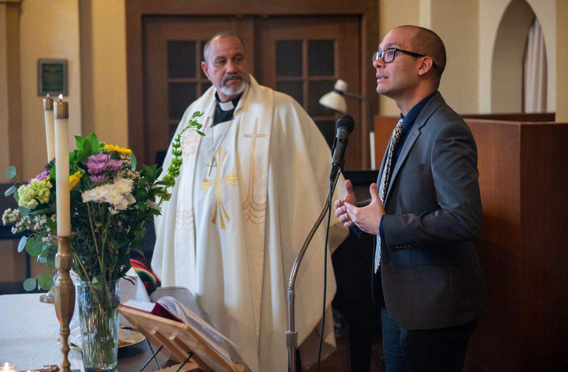 Immigration attorney Kelvin Rosado-Rivera, right, stands with the Rev. Nelson Rabell-González to inform the parishioners of Iglesia Luterana Santa María Peregrina in Stockton about their rights if they are approached by federal officials, during a recent church service.