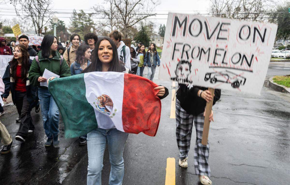 Zahira Afanador holds a Mexican flag as she joins fellow McClatchy High School students during a walk-out on Thursday to protest President Donald Trump’s executive orders.